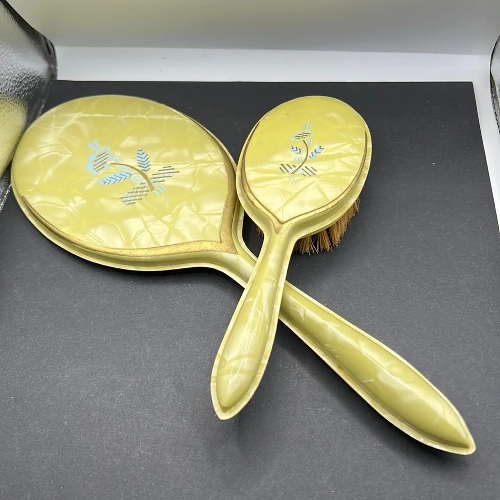 Vintage yellow celluloid vanity mirror, comb and brush set